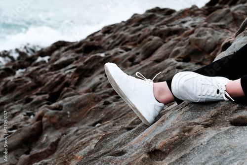 pair of feet resting against rocks after a short hike