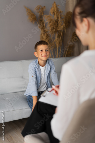 Принти на полотні Preschooler boy visiting psychotherapist, woman and child talking about problem,