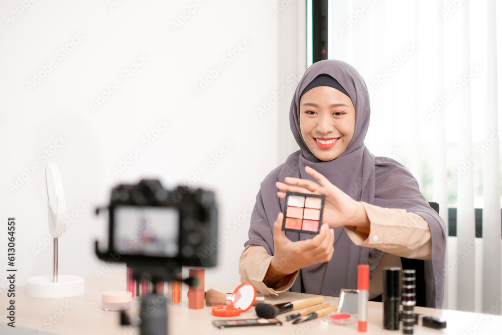 Beauty blogger applying makeup live and selecting professional cosmetics with expertise, showcasing her captivating artistry.