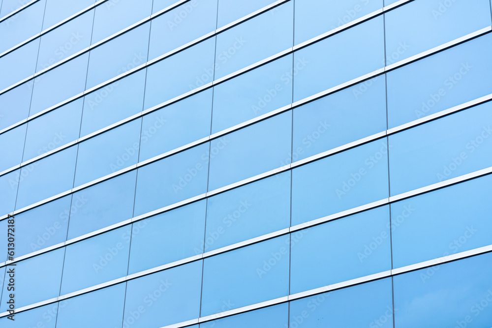 Part of a modern glass building, an aluminum facade that reflects the blue sky. Part of a modern glass building, an aluminum facade that reflects the blue sky.