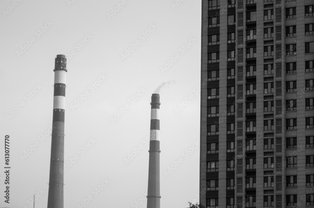 Black and white photos of chimneys and apartments, concept of urban pollution