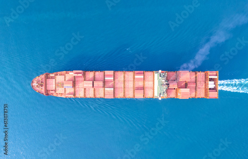 Top view Logistics and transportation of Container Cargo ship and Cargo plane with working crane bridge in shipyard at sunrise, logistic import export and transport industry background