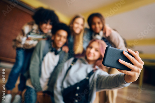 Close up of teenagers take selfie at high school.