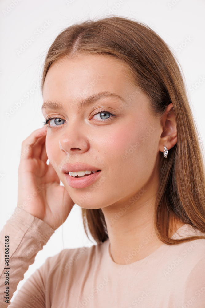 Beautiful young girl with fresh healthy skin. Woman advertise ear-rings. White background. Earrings closeup. Blond european woman with long hair with big lips, pretty smile. Cosmetology, scincare Beautiful young girl with fresh healthy skin. Woman advertise ear-rings. White background. Earrings closeup. Blond european woman with long hair with big lips, pretty smile. Cosmetology, scincare