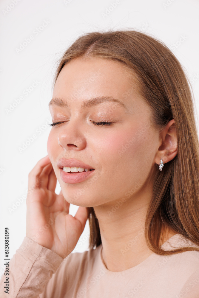 Beautiful young girl with fresh healthy skin. Woman advertise ear-rings. White background. Earrings closeup. Blond european woman with long hair with big lips, pretty smile. Cosmetology, scincare Beautiful young girl with fresh healthy skin. Woman advertise ear-rings. White background. Earrings closeup. Blond european woman with long hair with big lips, pretty smile. Cosmetology, scincare