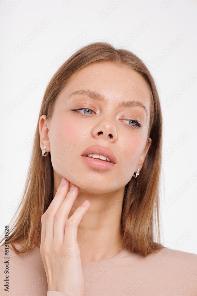 Beautiful young girl with fresh healthy skin. Woman advertise ear-rings. White background. Earrings closeup. Blond european woman with long hair with big lips, pretty smile. Cosmetology, scincare Beautiful young girl with fresh healthy skin. Woman advertise ear-rings. White background. Earrings closeup. Blond european woman with long hair with big lips, pretty smile. Cosmetology, scincare