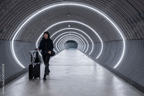 Business traveller walking through lit up tunnel at Zurich airport