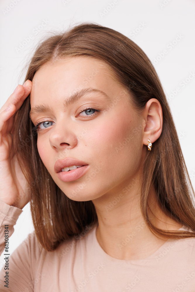 Beautiful young girl with fresh healthy skin. Woman advertise ear-rings. White background. Earrings closeup. Blond european woman with long hair with big lips, pretty smile. Cosmetology, scincare Beautiful young girl with fresh healthy skin. Woman advertise ear-rings. White background. Earrings closeup. Blond european woman with long hair with big lips, pretty smile. Cosmetology, scincare