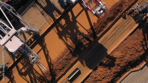 Brown minerals in the seaport ready for transportration. Aerial top view. photo