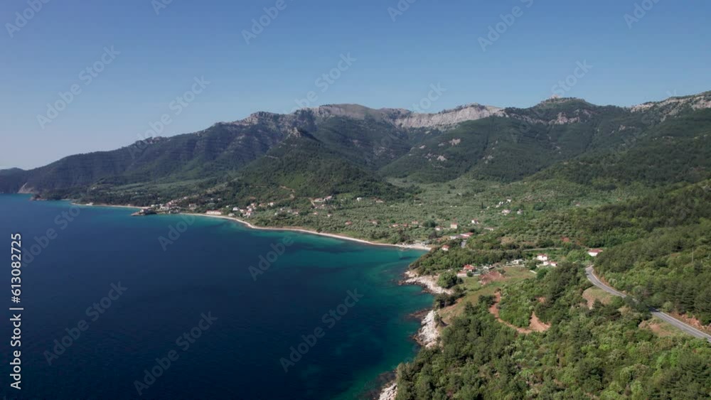 Aerial View Over Kinira View Point With High Mountain Peaks, Lush Green Vegetation, Mountain Road And Tropical Beaches In The Distance, Thassos Island, Greece Aerial View Over Kinira View Point With High Mountain Peaks, Lush Green Vegetation, Mountain Road And Tropical Beaches In The Distance, Thassos Island, Greece
