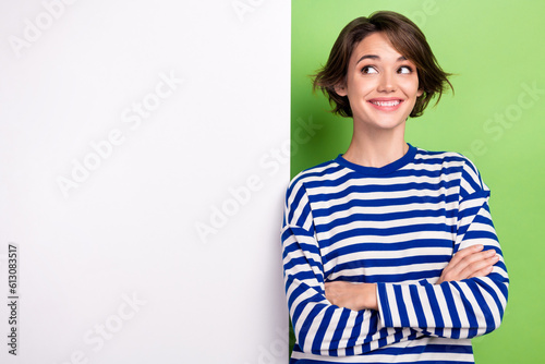 Portrait of young girl folded hands look empty space mockup cheerful pricelist stomatology dentistry isolated on green color background