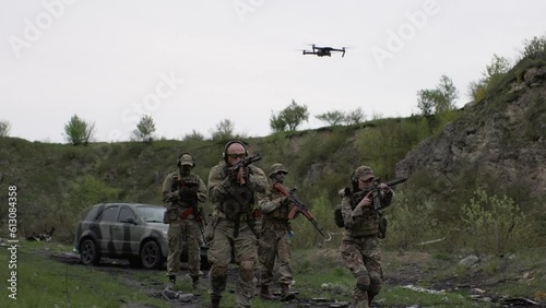 Group of Ukrainian military using a drone to detect enemy positions