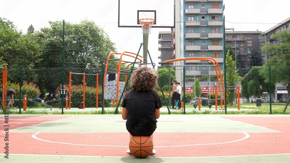 Italy, Milan 2023 boy kid child 9 years old play basketball in a park