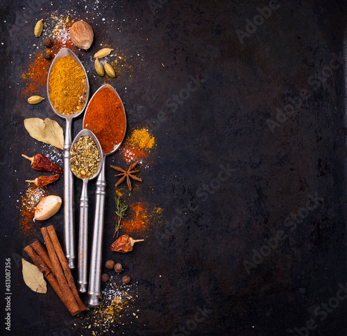 Different spices and herbs on a black background