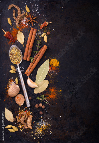 Different spices and herbs on a black background