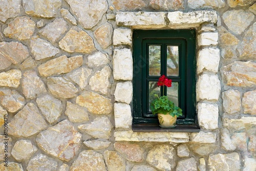 Window in old stone house with flower. High quality photo