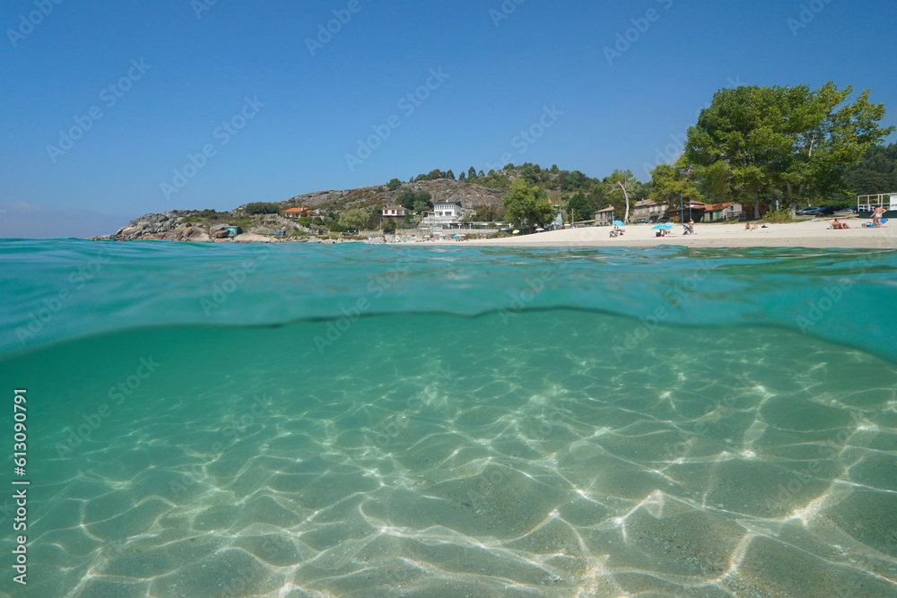 Beach shore in summer on the Atlantic coastline in Spain, Galicia, split level view over and under water surface, Rias Baixas