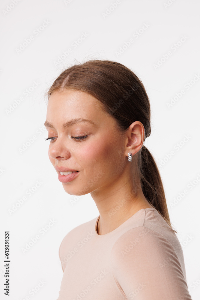 Beautiful young girl with fresh healthy skin. Woman advertise ear-rings. White background. Earrings closeup. Blond european woman with long hair with big lips, pretty smile. Cosmetology, scincare Beautiful young girl with fresh healthy skin. Woman advertise ear-rings. White background. Earrings closeup. Blond european woman with long hair with big lips, pretty smile. Cosmetology, scincare