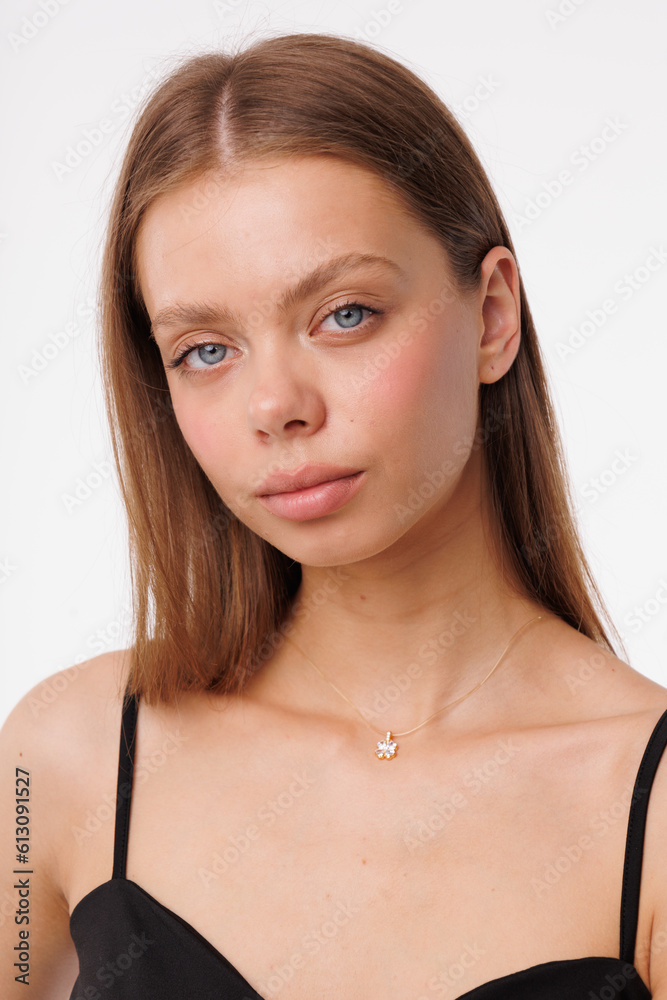 Beautiful young girl with fresh  healthy skin. Woman advertise ear-rings. White background. Earrings closeup. Blond european woman with long hair with big lips, pretty smile. Cosmetology,  scincare