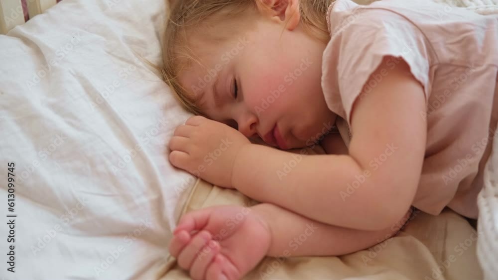 Peaceful adorable baby sleeping on his bed at home. Sleeping newborn baby concept. One year old baby girl sleeps peaceful at domestic room interior background. Serene dream. Cute Face Close Up. Peaceful adorable baby sleeping on his bed at home. Sleeping newborn baby concept. One year old baby girl sleeps peaceful at domestic room interior background. Serene dream. Cute Face Close Up.