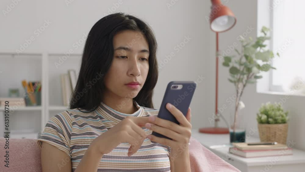 Asian girl using smart phone at home morning Asian girl using smart phone at home morning