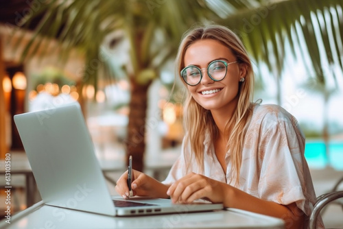 Trendy beautiful school girl smiling, wearing round metal glasses. Studying in internet from summer terrace with laptop, she is in a prestigious elementary school. Luxury background. AI generative
