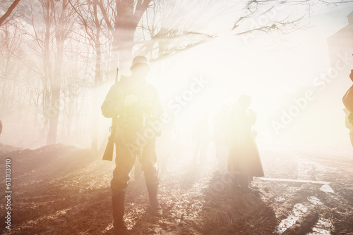 Dramatic Misty View On German Wehrmacht Infantry Soldier In World War Ii Standing In Dramatic Backlight Through Smoke During Historical Reenactment. Black And White Colors. Yellow Sunlight, Sunbeam. © Grigory Bruev