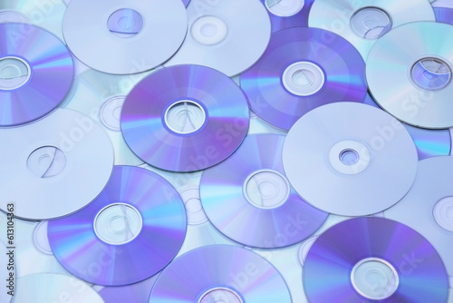 Lots of old CDs are laid out as a background.