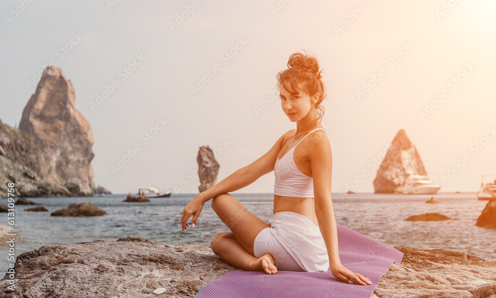 Fitness woman sea. A happy middle aged woman in white sportswear exercises morning outdoors on a beach with volcanic rocks by the sea. Female fitness pilates yoga routine concept. Healthy lifestyle. Fitness woman sea. A happy middle aged woman in white sportswear exercises morning outdoors on a beach with volcanic rocks by the sea. Female fitness pilates yoga routine concept. Healthy lifestyle.