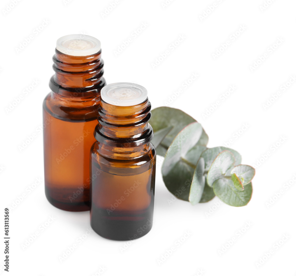 Bottles of eucalyptus essential oil and plant branch on white background Bottles of eucalyptus essential oil and plant branch on white background