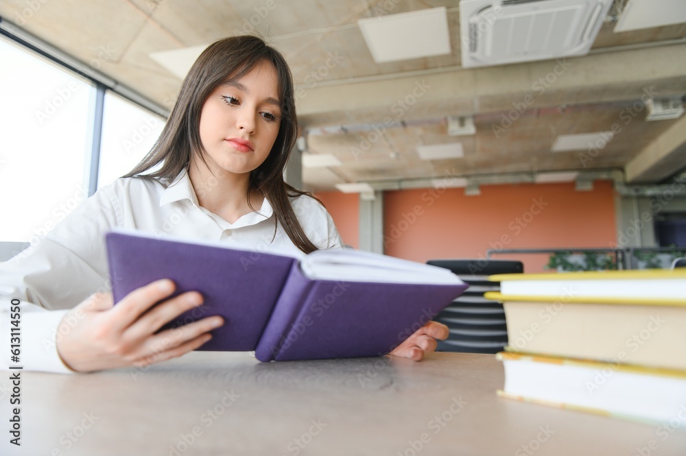 education and school concept - student girl studying and reading book at school. education and school concept - student girl studying and reading book at school.