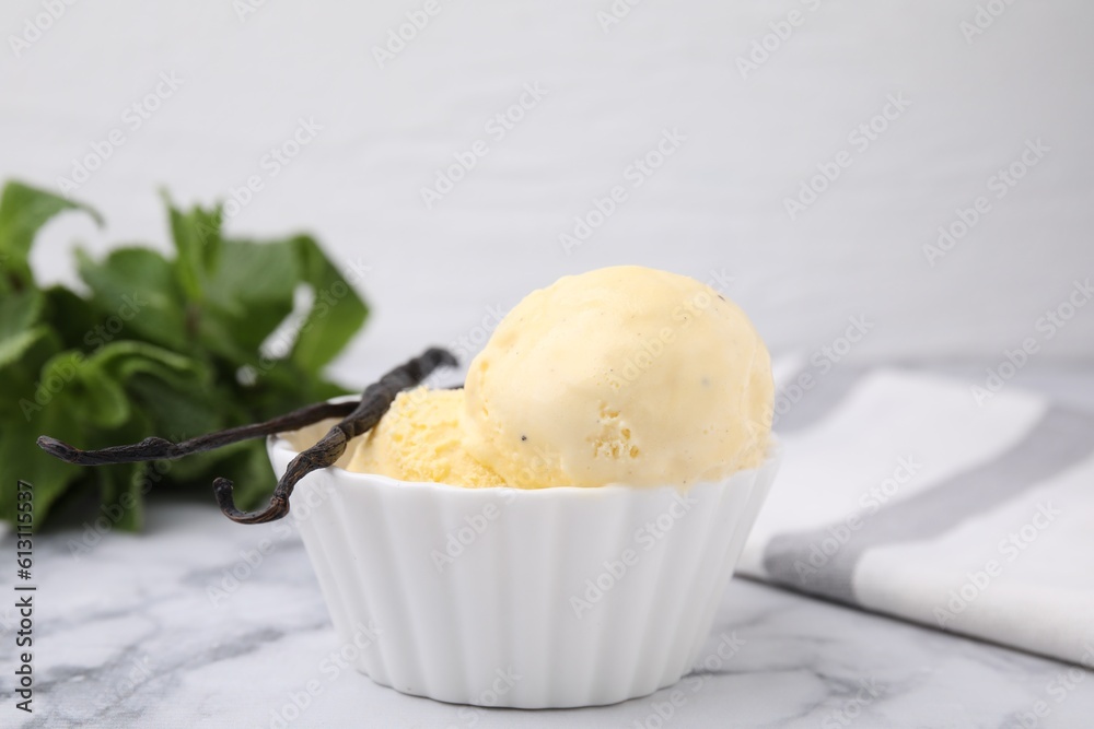 Delicious ice cream and vanilla pods on white marble table, closeup Delicious ice cream and vanilla pods on white marble table, closeup