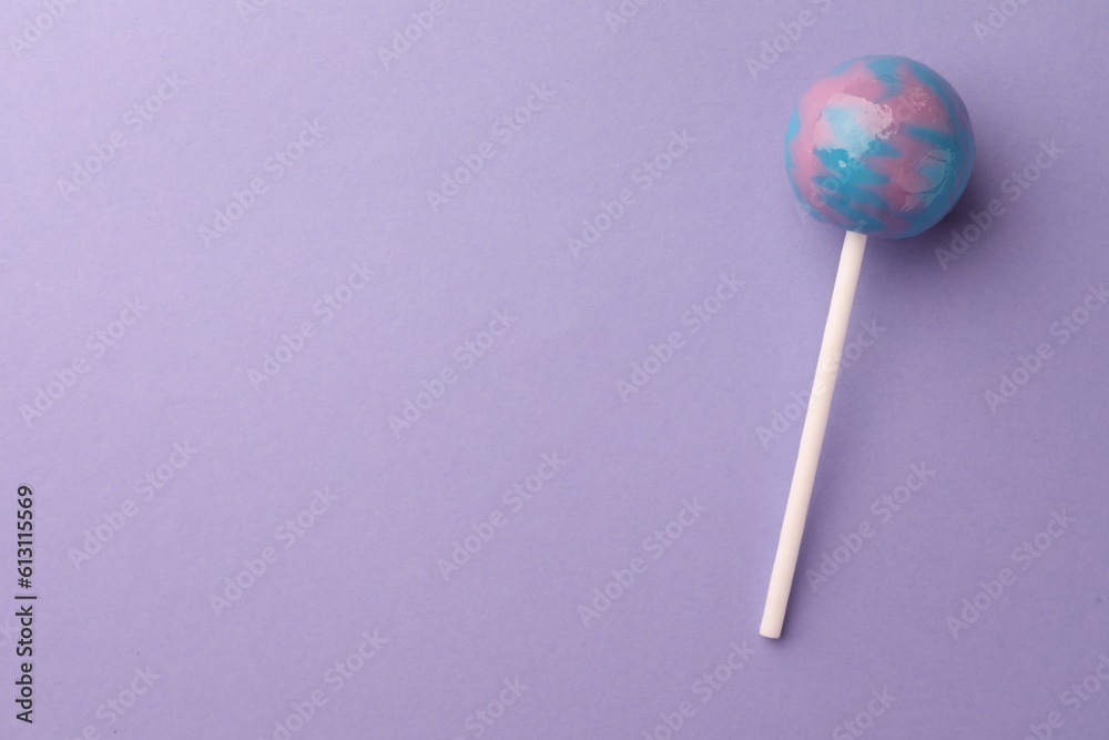 Tasty lollipop on violet background, top view. Space for text Tasty lollipop on violet background, top view. Space for text