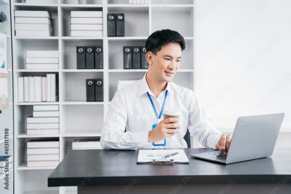 Asian businessman working at office with laptop and documents on table. Asian businessman working at office with laptop and documents on table.
