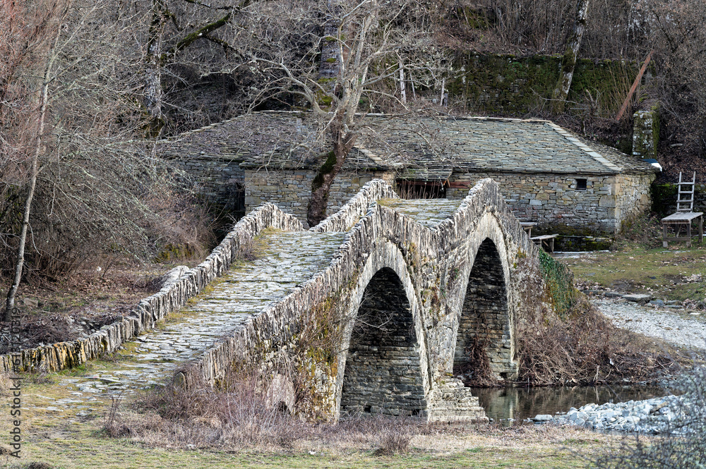 View of the traditional stone Mylos Bridge in Zagori of Epirus, Greece. View of the traditional stone Mylos Bridge in Zagori of Epirus, Greece.