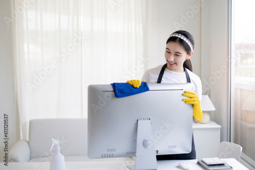 Asian beautiful young woman makes cleaning with a spray feel happy