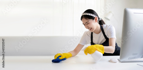 Asian beautiful young woman makes cleaning with a spray feel happy