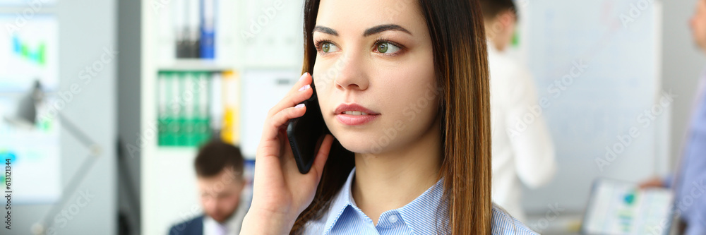 Portrait of beautiful businesswoman with phone in office. Business consultant and stay connected concept Portrait of beautiful businesswoman with phone in office. Business consultant and stay connected concept