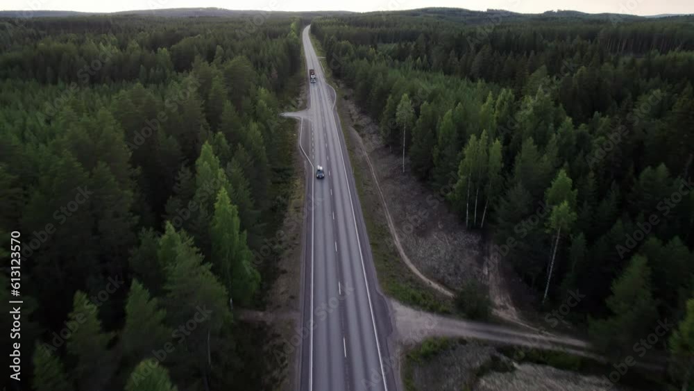 Stunning Drone Shot of Lonely Forest Road in Northern Finland, Car Passing By, Truck Carrying Wood Stunning Drone Shot of Lonely Forest Road in Northern Finland, Car Passing By, Truck Carrying Wood