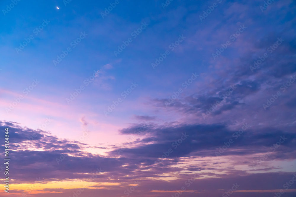 The sky glowed with color at dusk, with the clouds tinted with colors. Sunrise and sunset sky background.