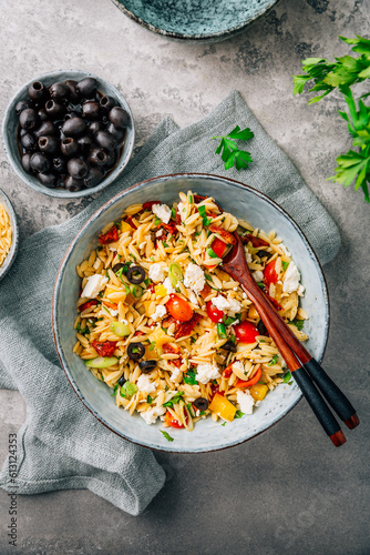 Obraz na płótnie Homemade orzo pasta salad with feta, olives, tomatoes