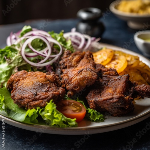 Close-Up Shot of Haitian Griot with Fried Plantains and Salad photo