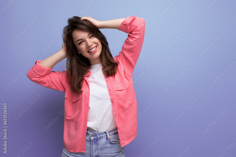 well-groomed european brunette 30s woman in pink shirt on studio background well-groomed european brunette 30s woman in pink shirt on studio background