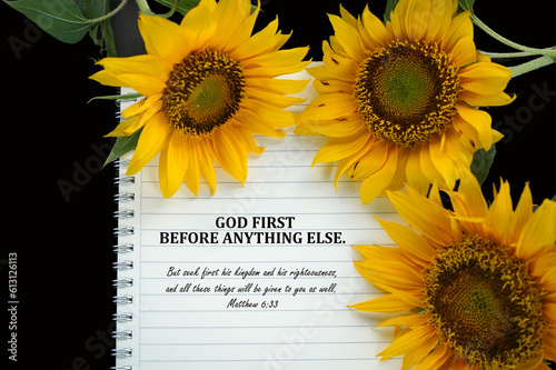 Fototapeta Naklejka Na Ścianę i Meble -  Bible verse quote - God First before anything else. Matthew 6:33 But seek first his kingdom and his righteousness, and all these things will be given to you as well. On notebook and sunflowers.