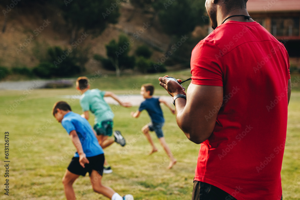 Sports trainer coaching a primary school team Sports trainer coaching a primary school team