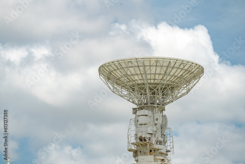 isolated earth terminal  satellite communication receiver with cloudy sky. photo