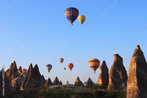 Colorful hot air balloons flying over the fairy chimneys in Nevsehir, Cappadocia