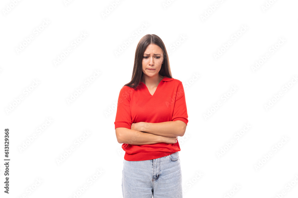 young distressed caucasian brunette in a red short sleeve shirt on a white background with copy space young distressed caucasian brunette in a red short sleeve shirt on a white background with copy space