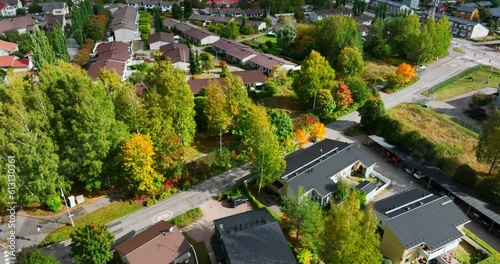 Aerial view following a car driving in a fall colored community of Northwest Helsinki, Finland photo