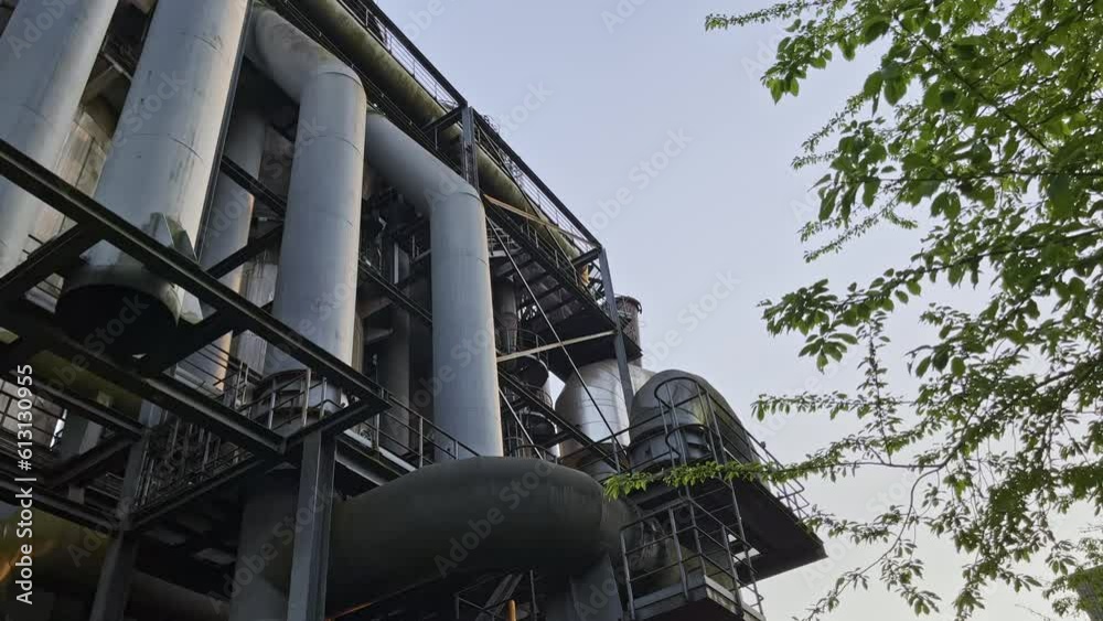 Large old pipes of an industrial building in the evening mood of the Landscape Park, Duisburg, Germany Large old pipes of an industrial building in the evening mood of the Landscape Park, Duisburg, Germany